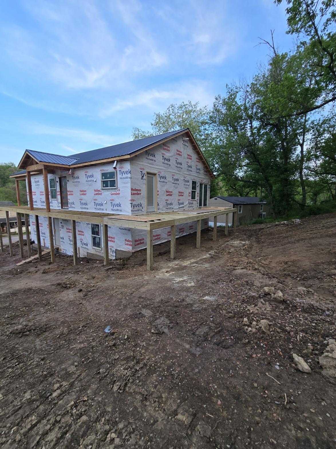 Back exterior of modern farmhouse under construction in Glouster Ohio with large windows