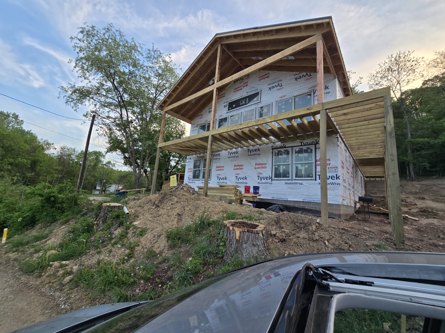 Exterior framing and house wrap during home build in Glouster Ohio with deck structure